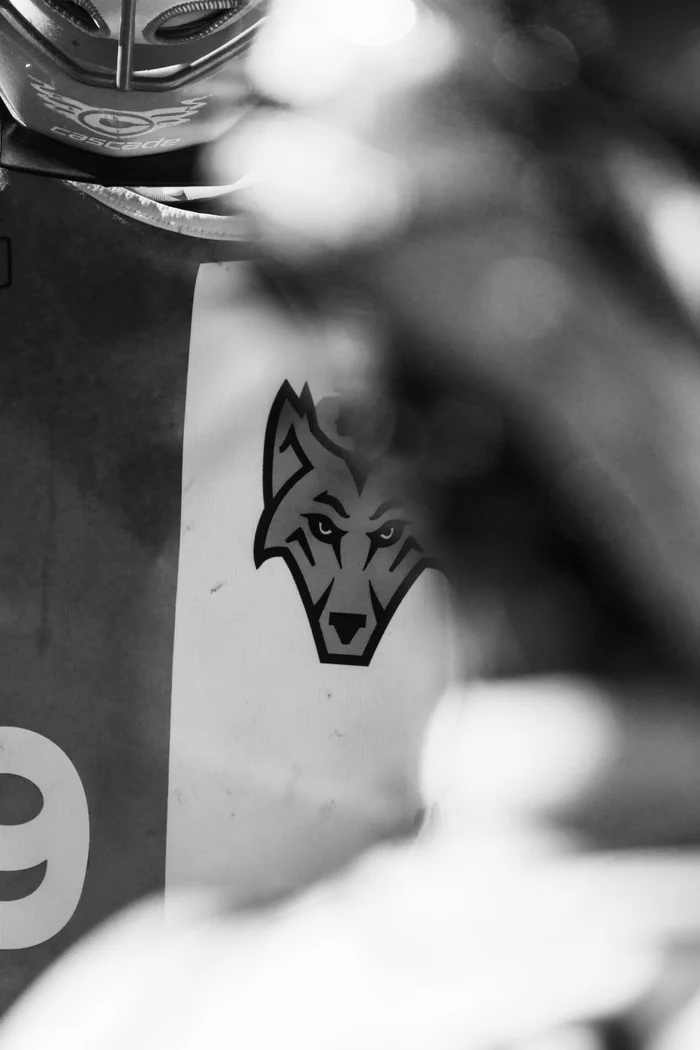 Close-up of the Premier West wolf on a player’s jersey